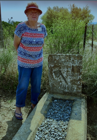 Daphne McNeill at the grave of the 1846 victim, after relating the story of the event that precipitated ‘The War of the Axe.’ (Photo: Sue Gordon)